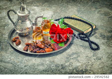 Tea and red rose flower, holy book quran 29542582