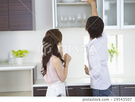 A couple standing in the kitchen A couple standing in the kitchen 29543507