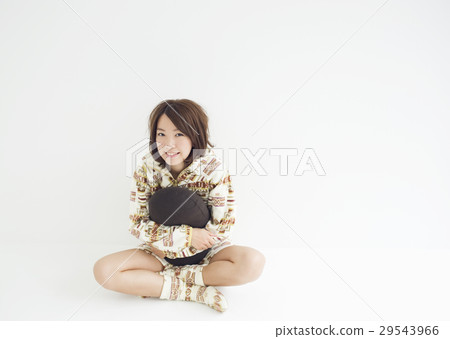 A young woman holding a cushion A young woman holding a cushion 29543966