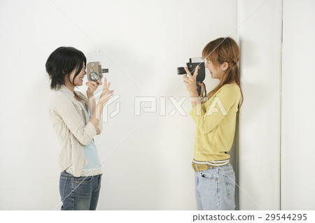 Women playing with camera Women playing with camera 29544295