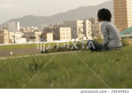 A woman sitting on a riverbed 29544463