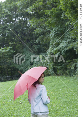 A woman holding an umbrella A woman holding an umbrella 29544636