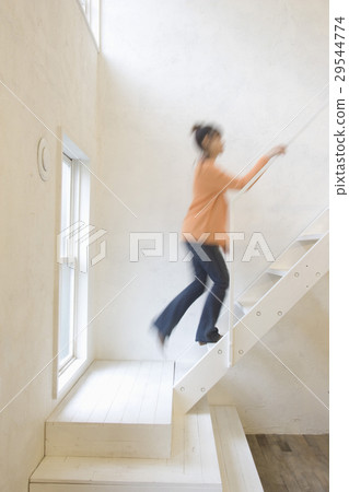 A woman climbing the stairs 29544774