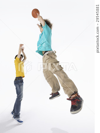 A young man playing basketball 29545881
