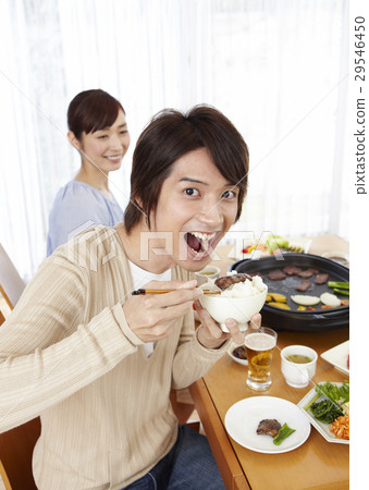 A couple eating grilled meat A couple eating grilled meat 29546450