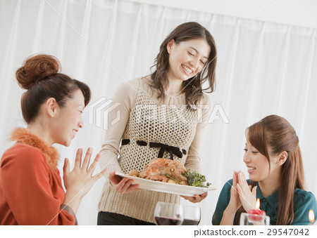 A woman carrying roast turkey 29547042