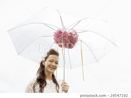 A young woman holding an umbrella 29547192
