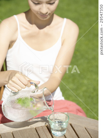 A young woman poured water A young woman poured water 29547350