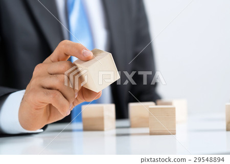 Businessman making tower Businessman making tower 29548894
