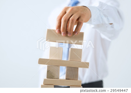 Businessman making tower Businessman making tower 29549447
