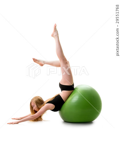 Female gymnast poses on stomack on green fitball 29551768