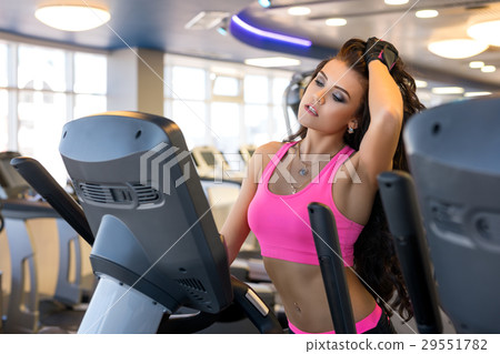 Beautiful brunette in sexy pink on running track. 29551782