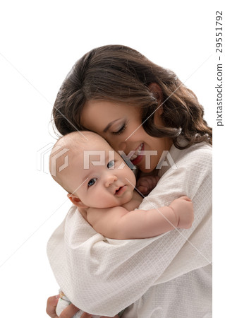 Young mother keeping lovely baby boy in her arms Young mother keeping lovely baby boy in her arms 29551792