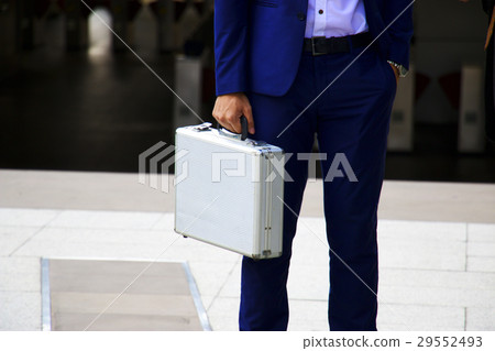 Man is holding metallic brief case Man is holding metallic brief case 29552493