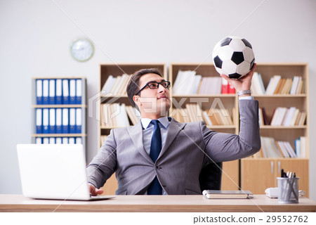 Businessman with football ball in office 29552762