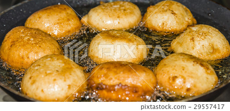Donuts frying in deep fat. Preparation of traditio 29557417