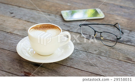Hot coffee, glasses, and smartphone. 29558031