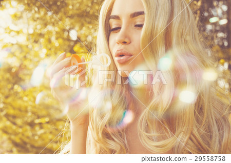 Beautiful blonde blowing bubbles 29558758