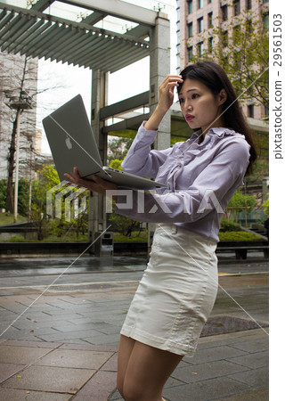 Business photography, the strong woman uses a laptop to organize the appearance Business photography, the strong woman uses a laptop to organize the appearance 29561503