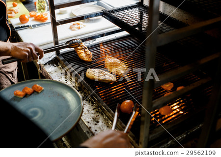 Cooks grilled meat on fire 29562109