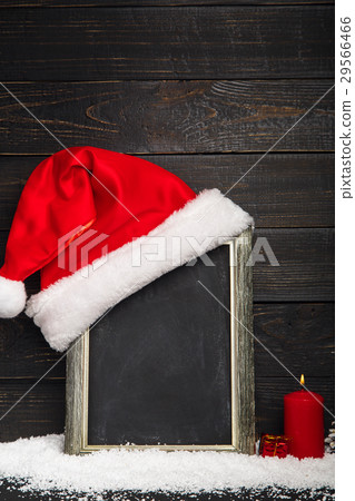 Red Santa hat on the chalkboard with snow Red Santa hat on the chalkboard with snow 29566466