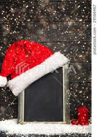 Red Santa hat on the chalkboard with snow Red Santa hat on the chalkboard with snow 29566467