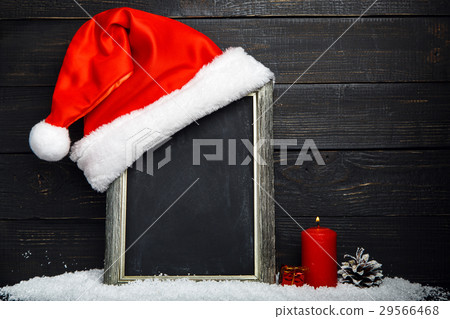 Red Santa hat on the chalkboard with snow 29566468