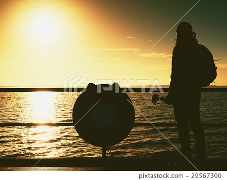 Hunched artist photograph with camera on tripod.  29567300