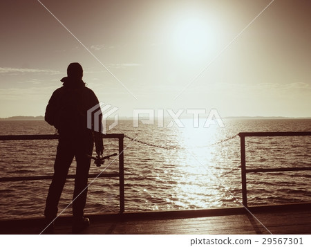 Alone artist on wooden sea bridge.  Man at sea  29567301