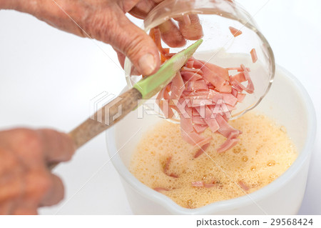 Omelet preparation : Mixing ingredients with eggs 29568424