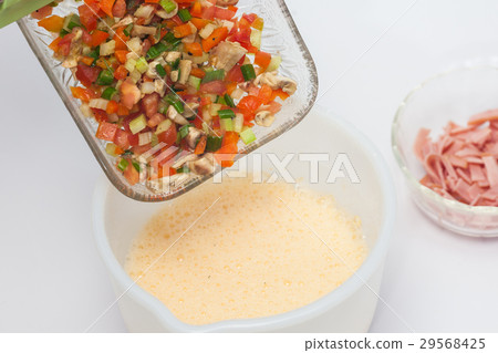 Omelet preparation : Mixing ingredients with eggs Omelet preparation : Mixing ingredients with eggs 29568425