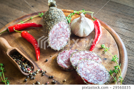 Slices of saucisson on the wooden board Slices of saucisson on the wooden board 29568835