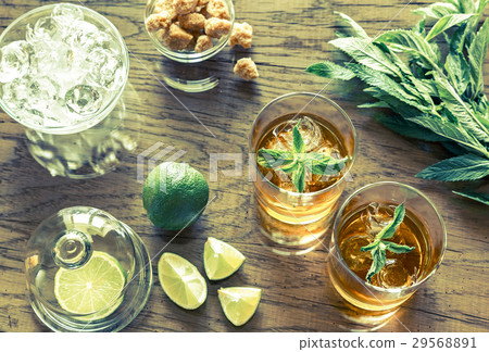 Glass of rum on the wooden background Glass of rum on the wooden background 29568891