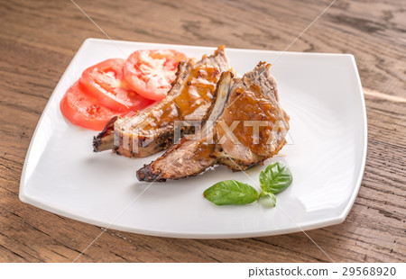 Portion of grilled pork ribs in barbecue sauce Portion of grilled pork ribs in barbecue sauce 29568920
