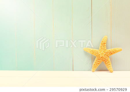 Starfish on a teal wooden background 29570929