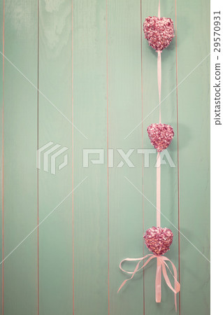 Pink shiny hearts on vintage green wood background 29570931