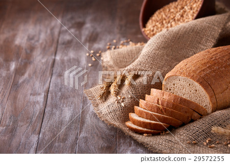 Slices of bread on burlap on the wooden table 29572255