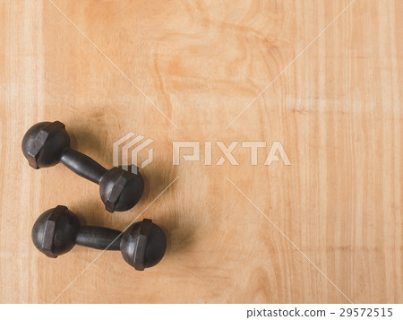 iron dumbbells on wooden table background iron dumbbells on wooden table background 29572515