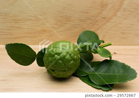 kaffir lime on a wooden background. kaffir lime on a wooden background. 29572667