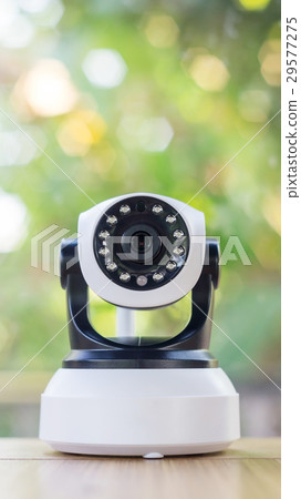 Security camera on a wooden table. 29577275