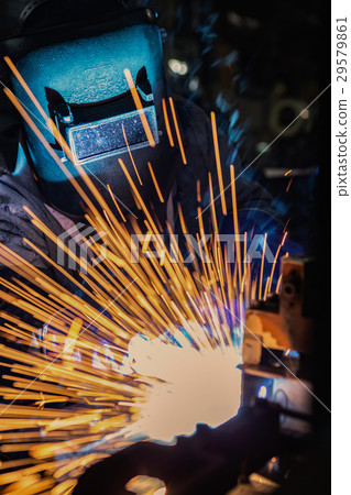 ndustrial worker cutting and welding metal  29579861