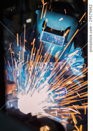 Worker welding steel in car factory 29579862