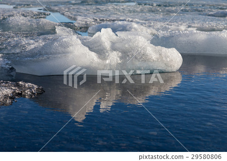 Ice on winter lagoon and reflection 29580806