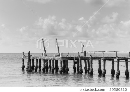 Long wooden bridge leading to ocean 29580810