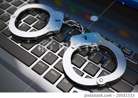 Handcuffs on laptop keyboard 29581533