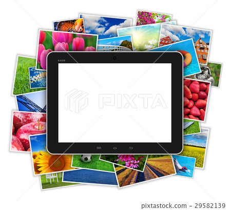 Blank tablet computer on heap of colorful photos Blank tablet computer on heap of colorful photos 29582139