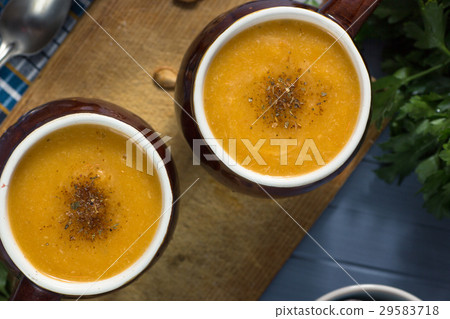 pumpkin cream soup in mugs on gray blue pumpkin cream soup in mugs on gray blue 29583718