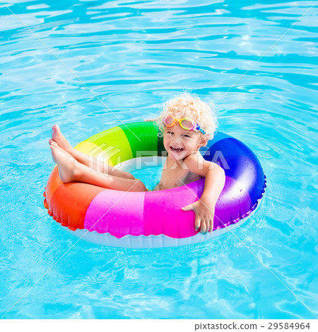 Child with toy ring in swimming pool 29584964