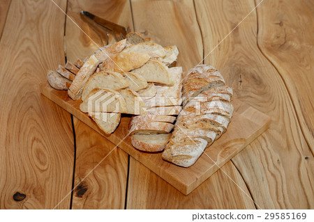 Cutted bread with seeds on board on table Cutted bread with seeds on board on table 29585169