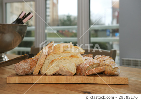 table with cutted bread on wooden board table with cutted bread on wooden board 29585170